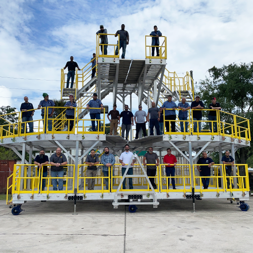 Workers standing on completed metal stand